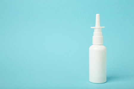 Nasal drops medicine bottle on blue background. Top viewの写真素材