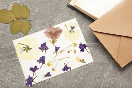 Pressed and dried flowers with twine on gray concrete background.の写真素材