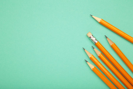 Graphite pencil with eraser on mint background. School stationery. Top viewの写真素材