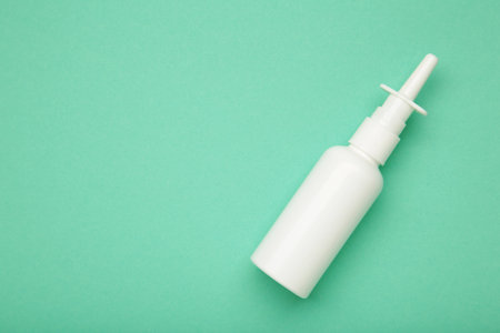 Nasal drops medicine bottle on mint background. Top viewの写真素材