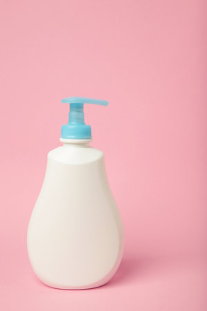 White plastic bottle of liquid soap on pink background. Top viewの写真素材