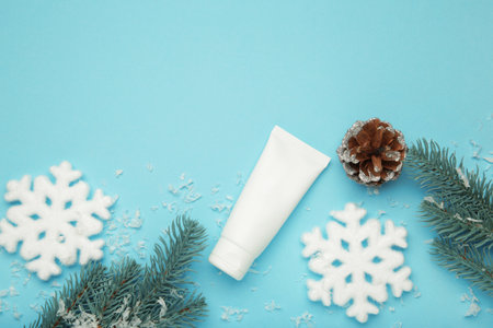 Winter skin care concept. Cosmetic moisturizer cream and snowflakes on blue background. Top viewの写真素材