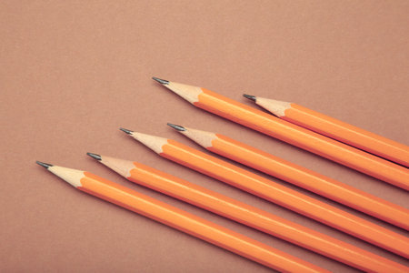 Pencils on brown background. Top viewの写真素材