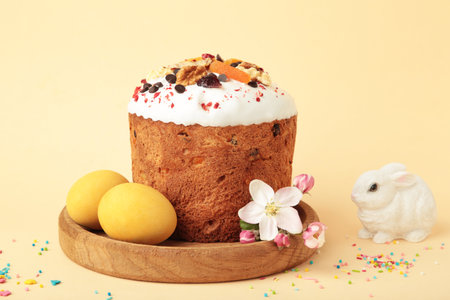 Traditional easter cakes with colorful sprinkles, with eggs, a bunny figurine, and spring flowers on...