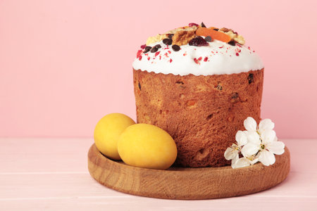 Traditional easter cakes with colorful sprinkles, with eggs, a bunny figurine, and spring flowers on...