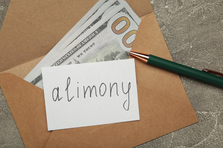 Envelope with word Alimony and money on gray background. Top viewの写真素材