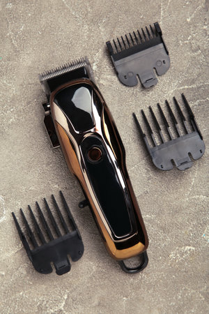 Hair clipper on gray concrete background. Modern hair clipper. Vertical photo