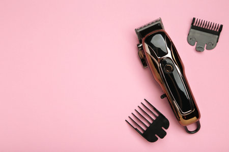 Hair clipper on pink background. Modern hair clipper. Top view