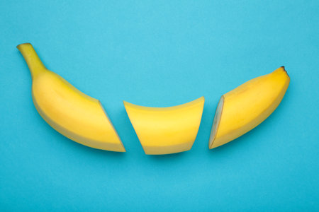 Cut banana, slices on pastel blue background. Minimalist concept. Top viewの写真素材