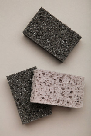 New absorbent black sponge on gray background. Black kitchen sponges. Top viewの写真素材
