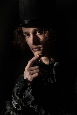 The young man in a top hat, tailcoat, lace. Portrait. Boho.の写真素材