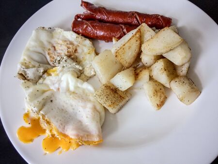 A white plate topped with different types of foodの写真素材