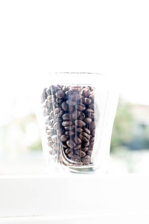 morning mood. coffee production. coffee trade. roasted coffee beans in a glass for breakfastの写真素材