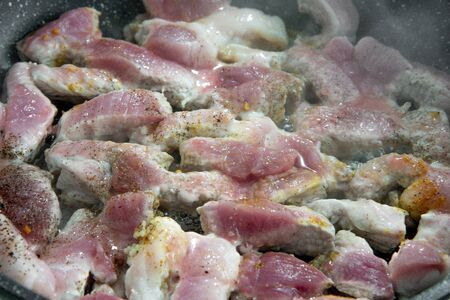 Pork is fried in a pan. Fried pork Roast beef close-up. Cut meat. Medium rareの写真素材