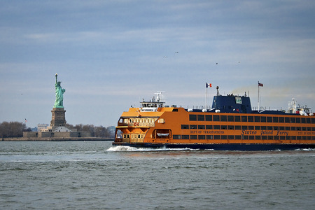 Staten Island Ferry sailing by the statue of libertyのeditorial素材