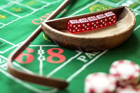 5 Dice in a bowl and a stick on a craps tableの写真素材