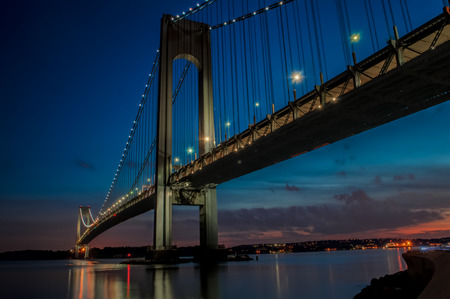 The bridge connecting Brooklyn to Staten Island named Verrazano bridge seen at duskの写真素材