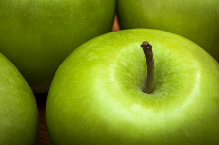 Macro of delicious green apples, healthy snack options low in fat and high in fiber and vitaminsの写真素材