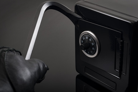 Home invasion and burglary concept with first person view of a burglar wearing black leather gloves...