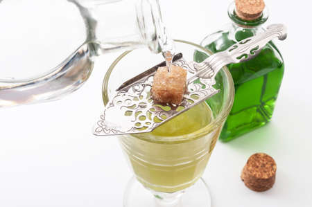 Alcohol, luxurious spirits and dangerous liquor conceptual idea with crystal glass of absinthe,...