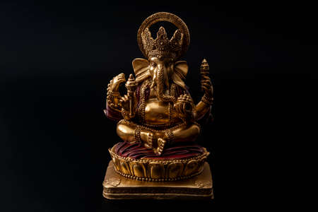 Happy Diwali, divine bless and spiritual harmony conceptual idea with Ganesh the hindu half elephant god of beginnings in meditation pose isolated on black background with clipping path cutoutのeditorial素材
