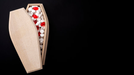 Prescription pharmaceutical drugs and deadly pill addiction as sickness concept with wooden coffin...