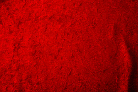 Abstract background and luxury cloth concept with red velvet fabric, mostly stretched but with a couple of  folds or creases with plenty of copy space for textの写真素材