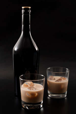 Coffee liqueur and alcoholic beverages based on milk and whiskey concept with Irish cream bottle and...