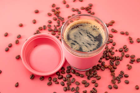 Coffee break, a shot of caffeine and energy in a cup of java concept theme with a reusable portable...