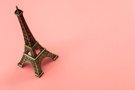 Travel to France and Paris landmark concept with minimalist miniature of Eiffel Tower isolated on pink background with copy spaceの写真素材