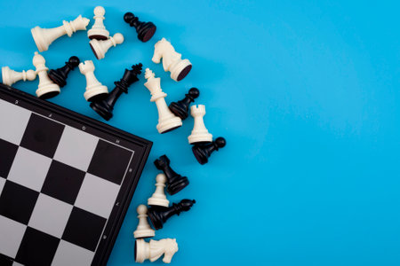 Critical thinking, winning chess tournament and mind game concept with chessboard and figures isolated on blue background with copy spaceの写真素材