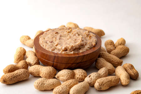 American breakfast, sweet food and snack high in calories concept with a bowl of crunchy peanut...