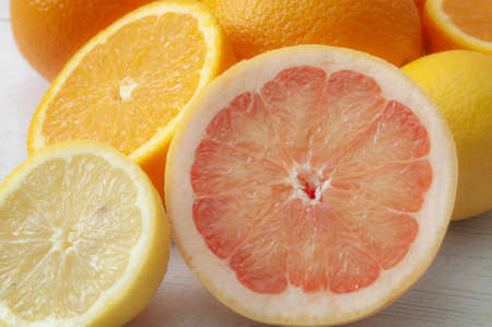 Fresh citrus fruits and food high in vitamin c concept theme with close up on a pile of mixed fruit...