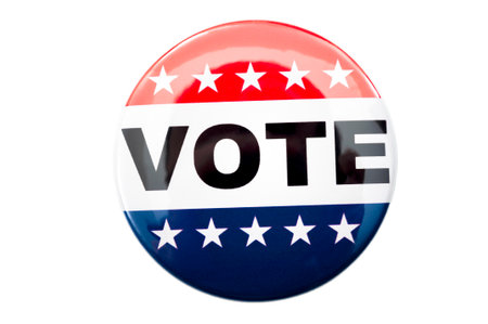 Democracy, presidential election and voting poll concept with red, white and blue vote glossy button pin with stars and stripes isolated on white background with clipping path cutoutの写真素材