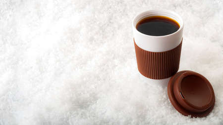 Hot coffee in paper cup with snow isolated on white background with copy spaceの写真素材