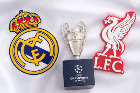 Croydon, UK - May 24, 2020: illustrative editorial of replica of the Champions league trophy, the emblem of Real Madrid and the badge of Liverpool (the teams that compete in the tournament final)のeditorial素材
