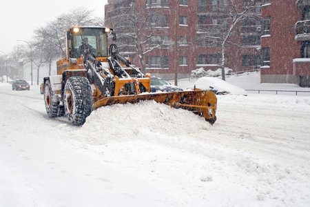 Truck with shovel remove snow.