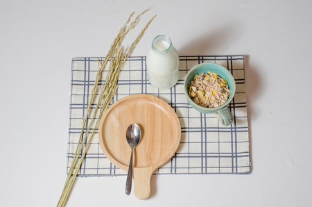 Breakfast with  Muesli and fresh milk and nice wooden plate and spoonの写真素材