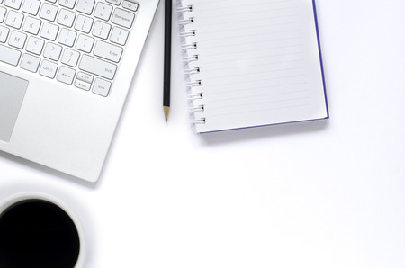 Laptop and note book and pencil and black coffee on white background with copy space.の写真素材