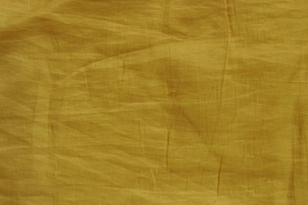 Yellow wrinkled fabric texture for backgroundの写真素材