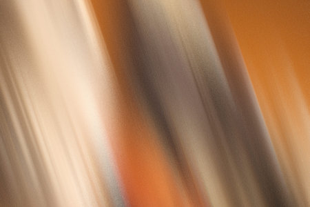 Warm bronze and earthy brown abstract texture with fine grainy surface and soft vertical shadowsの写真素材