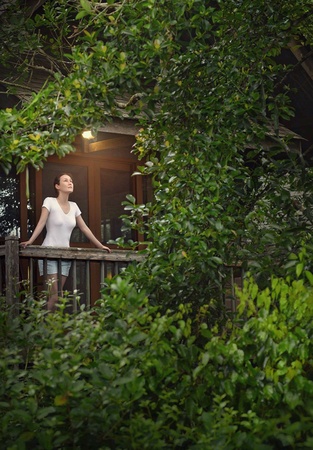 A girl standing at the balconyの素材