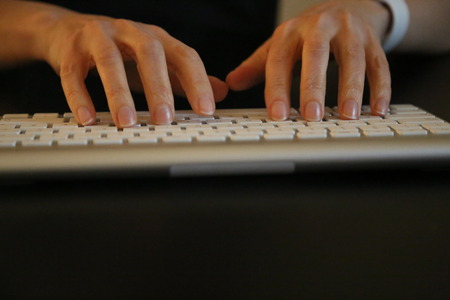 Woman's hands closeup computer keyboard