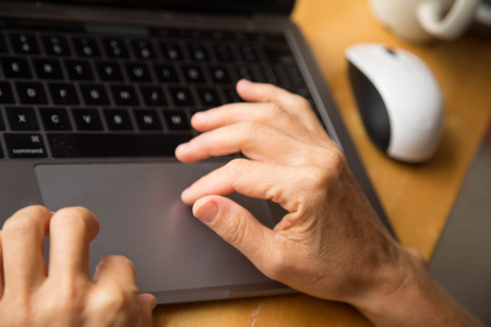 Female hands over computer keybppardの写真素材