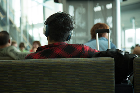 Back view young male headphone closeup