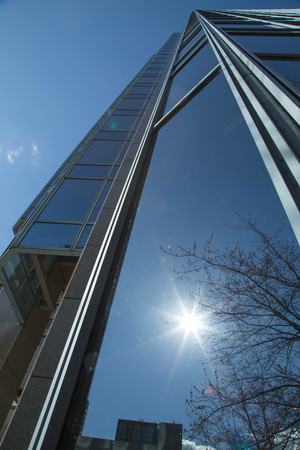 Sunshine reflections blue glass surface modern highrise