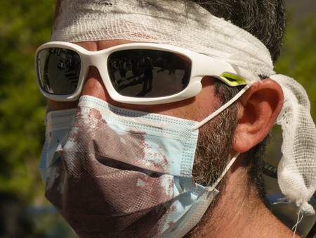 Close up plague covered fake dark blood man portrait close up outdoor zombie walkの写真素材