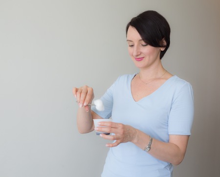 Female nurse dipping clamp cotton ball into medical liquidの写真素材