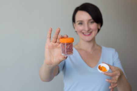 Female doctor portrait hands holding pills copy spaceの写真素材