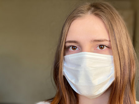 Portrait young caucasian female wearing medical mask coronavirusの写真素材